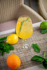 Alcoholic cocktail. Orange gin with rosemary, beach refreshment cocktail at the bar