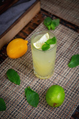 Alcoholic classic refreshing mojito cocktail with lime, mint and ice cubes, on the summer terrace of the restaurant
