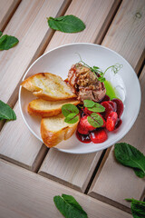 Chicken liver pate with croutons and strawberries in sweet sauce