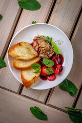 Chicken liver pate with croutons and strawberries in sweet sauce