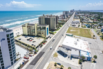 Aerial looking south over Daytona Beach, Florida neighborhoods, beachfront hotels and condos and the Atlantic Ocean.