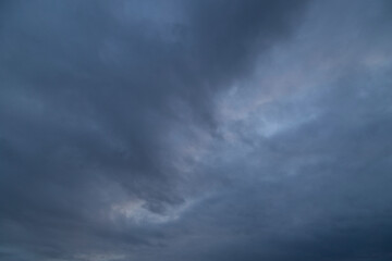 Naklejka na ściany i meble Background of the sky in stormy weather.Dark sky in bad weather.