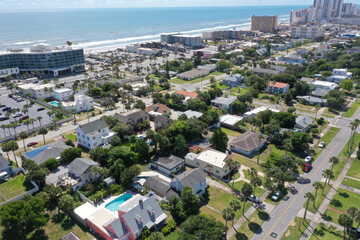 Aerial looking east to the Atlantic Ocean over Daytona Beach, Florida neighborhoods, beachfront hotels and condos.