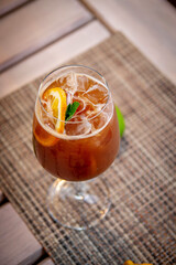 Alcoholic refreshing cocktail coffee ginger ale with tonic, on the summer terrace of the restaurant.