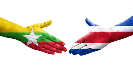 Handshake between Costa Rica and Myanmar flags painted on hands, isolated transparent image.