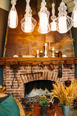 brick fireplace with wooden table and wicker chair. 