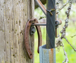 Rusted horseshoe hanging on the electrical wooden pole