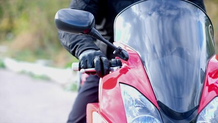 motorcycle pilot sits behind the wheel clamps the lever
clutch and turn the throttle. man on a motorcycle - Powered by Adobe