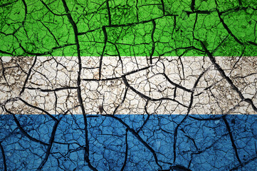 Dry soil pattern on the flag of Sierra Leone. Country with drought concept. Water problem. Dry cracked earth country.	