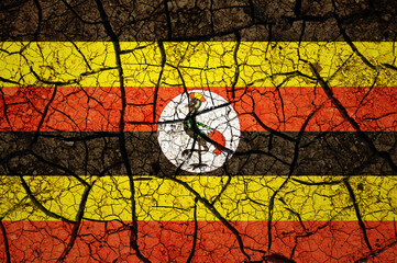 Dry soil pattern on the flag of Uganda. Country with drought concept. Water problem. Dry cracked earth country.	