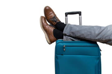 Tourist is relaxing and lying with legs on suitcase.