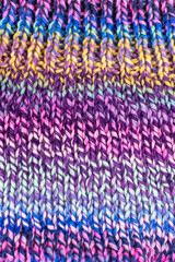 hand knitting fabric texture background in colours of purple and green