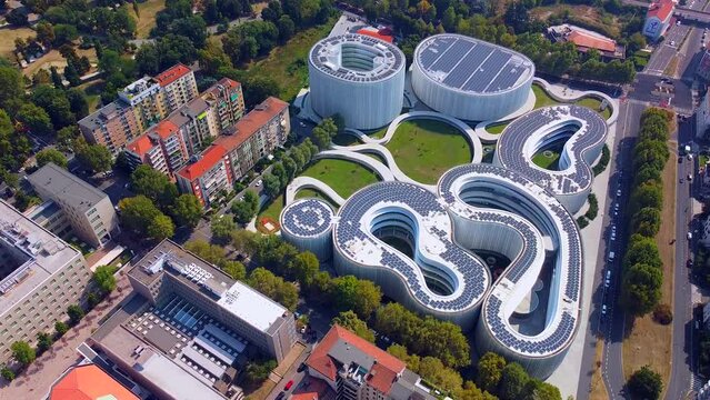 Aerial view of solar panels on the roof. The new campus of the SDA Bocconi School of Management is a modern building with classrooms. Autumn trees. Ecological energy. Milan Italy 11.2022
