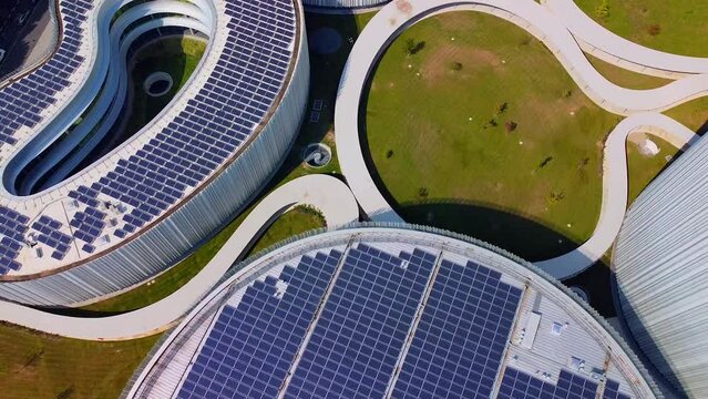 Aerial view of solar panels on the roof. The new campus of the SDA Bocconi School of Management is a modern building with classrooms. Autumn trees. Ecological energy. Milan Italy 11.2022