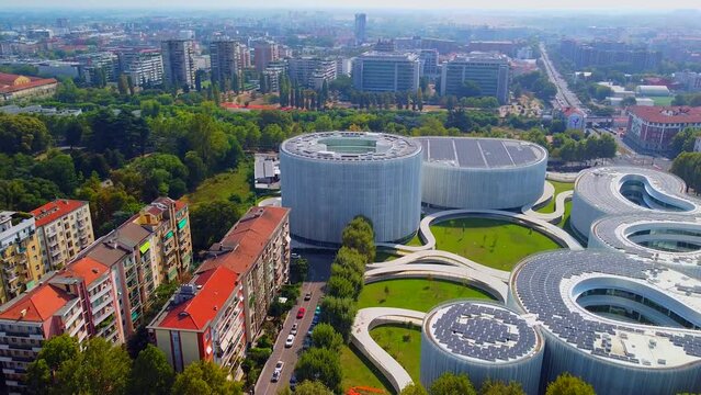Aerial view of solar panels on the roof. The new campus of the SDA Bocconi School of Management is a modern building with classrooms. Autumn trees. Ecological energy. Milan Italy 11.2022