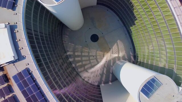 Aerial view of solar panels on the roof. The new campus of the SDA Bocconi School of Management is a modern building with classrooms. Autumn trees. Ecological energy. Milan Italy 11.2022