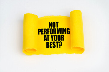 On a white surface, a yellow scroll of paper with the inscription - NOT PERFORMING AT YOUR BEST
