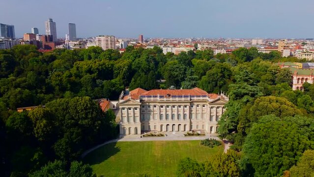 Aerial view of summer trees in Giardini Indro Montanelli park and skyline with new skyscrapers. View of modern business offices. Business. Tourism. Ecology. Clouds over the city. Green Planet. Milan. 