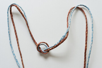 twisted paper ribbon chord with loose knot on blank paper