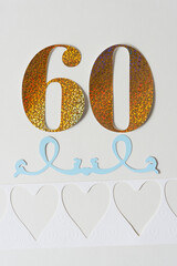 the number sixty with paper ornament