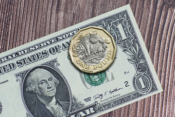 One American dollar bill with British pound coin. Exchange rate concept.