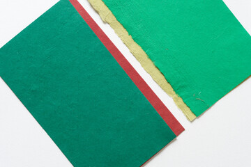 rough, textured green, red, and paisley green paper background
