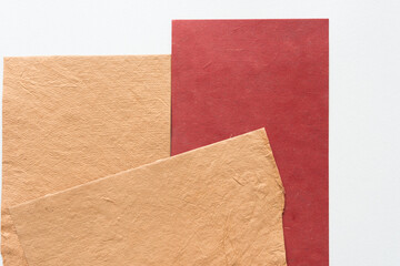 sand brown or yellow paper with texture and red card stock on blank paper