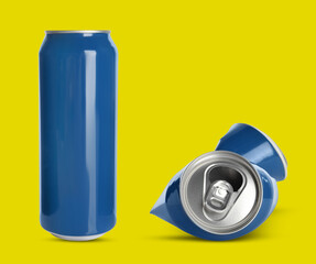 Whole and crumpled aluminum cans on yellow background