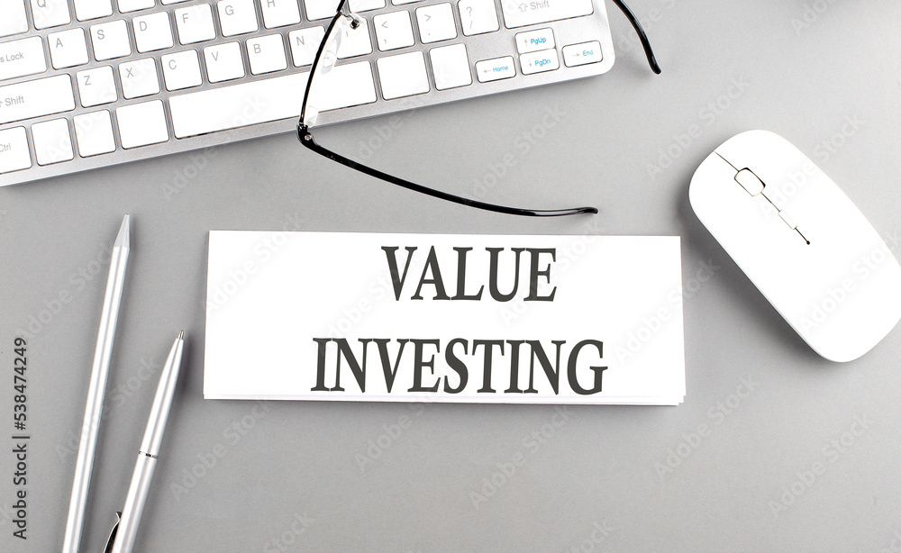 Poster value investing text on paper with keyboard on grey background