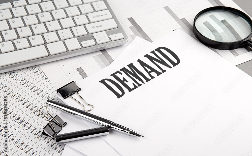 Poster demand text on paper with chart and keyboard, business concept