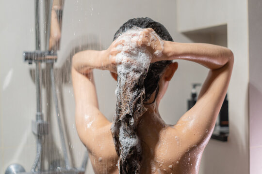 Woman bathing and washing her hair relaxed..