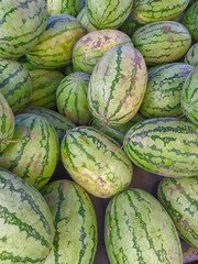 people selling fresh green watermelon at Indonesian street market