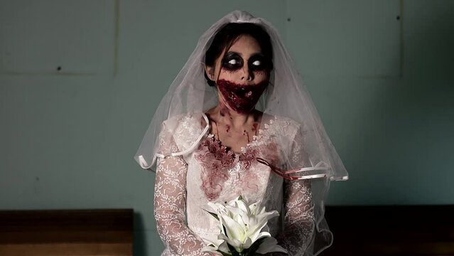 Portrait of asian woman make up ghost bride death and blood the horror is darkness scary horror scene for background,Halloween festival concept.