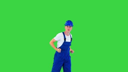 Happy and excited construction worker dancing on a Green Screen, Chroma Key.