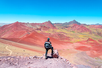 a man is taking a photo in rainbow mountain, peru
