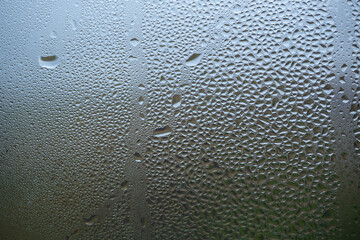 Drop of water on glass, rain. Sweaty window, background.