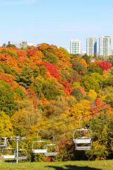 Ski lift, gondola, in autumn with beautiful fall colours overlooking city