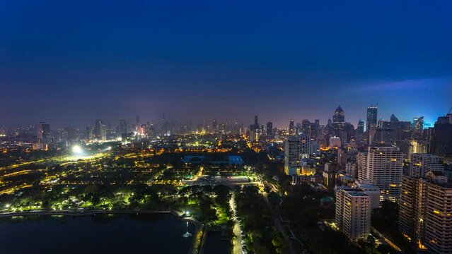 aerial view time lapse of nature public park for relax and exercise with view of skyscrapper in downtown center of business zone in Bangkok City, Thailand