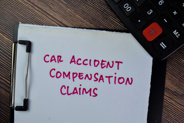 Concept of Car Accident Compensation Claims write on paperwork isolated on Wooden Table.