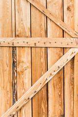Beautiful fresh larch wooden texture background on boards with door on wooden wall	