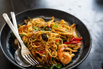spaghetti spicy seafood with squid shrimp and baby corn with pepper chili and black peppercorns in...