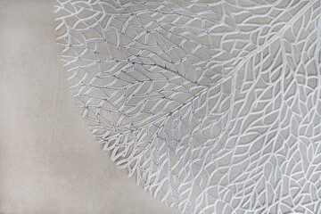 Abstract silver leaf like texture on mottled grey with copy space. Abstract and beautiful background