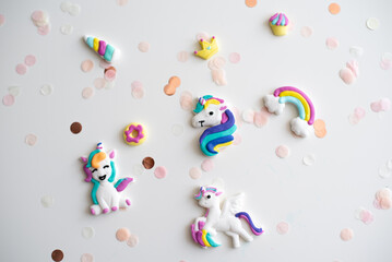 Handmade from color dough shape of unicorn, rainbow, colorful hearts and confetti for decorate cake...