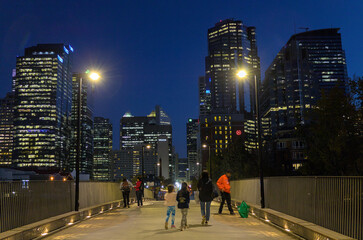 Fototapeta premium People crossing the bridge over the Bow River at night, Calgary