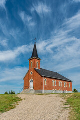 Fototapeta na wymiar Blue sky and clouds over St. Johns Lutheran Church in Edenwold, near Regina, SK 