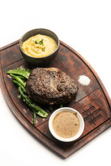 rib eye beef steak with butter sauce and gravy
