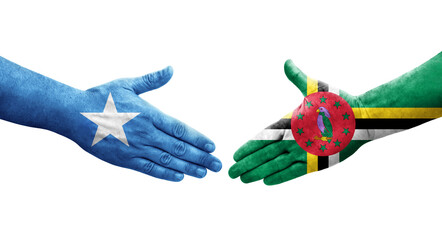 Handshake between Dominica and Somalia flags painted on hands, isolated transparent image.