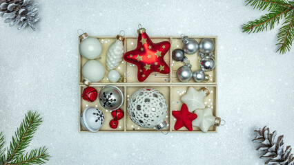 christmas ornaments with stars, balls, gift box, pine cones and fir branches