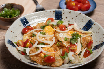 Spicy fried egg salad with vegetables, tomatoes, onions