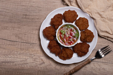 Fried Pork Cake with Ketchup and Chili Sauce on a white table top view. Asia Travel Cuisine concept.